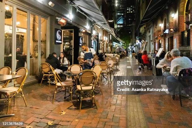 Usually busy laneway lined with restaurants is full of empty tables and a few customers on March 21, 2020 in Melbourne, Australia. Prime Minister...