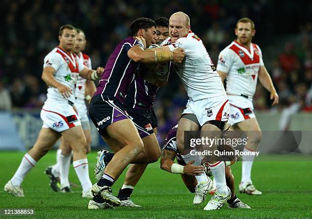 Michael Weyman of the Dragons is tackled by Jesse Bromwich of the Storm during the round 24 NRL match between the Melbourne Storm and the St George...