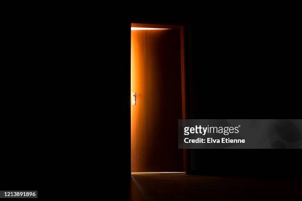 glowing sunlight illuminating the edges of an opening interior door - open stock pictures, royalty-free photos & images