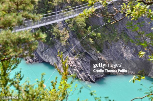 suspension bridge over a lake in the belledonne mountain range - wire rope stock pictures, royalty-free photos & images