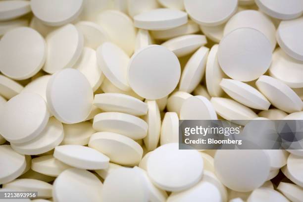 Uncoated tablets sit in a container following pressing during the manufacture of the Favipiravir antiviral medicine, a joint venture between the...