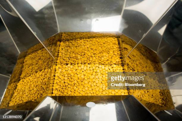 Finished tablets sit inside a packaging machine during the manufacture of the Favipiravir antiviral medicine, a joint venture between the Russian...
