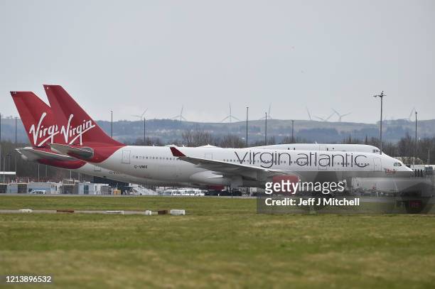 Virgin Atlantic planes sit on the runway at Glasgow Airport on March 21, 2020 in Glasgow, Scotland. Coronavirus has spread to at least 186 countries,...
