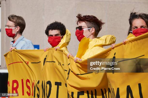 Environmental activists gather outside the Shell building to protest against fossil fuels as Shell holds its annual shareholders meeting on May 19,...