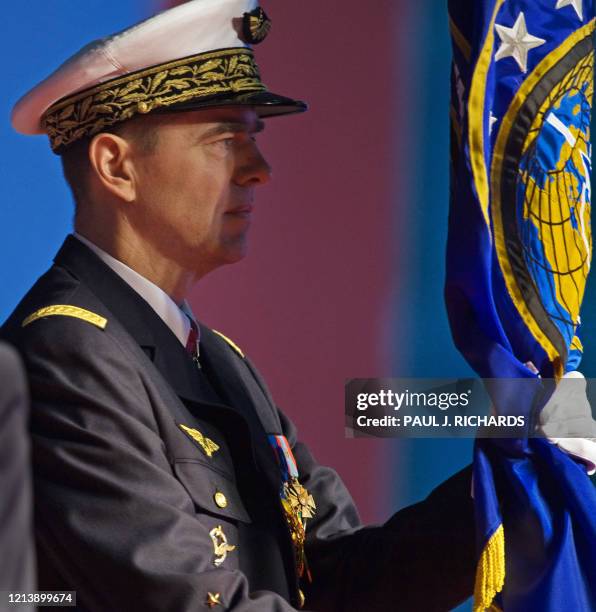 French General Stephane Abrial of the French Air Force accepts the command flag from US General James N. Mattis, USMC, during the ceremony...