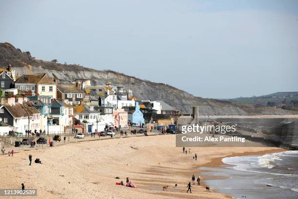 General view across Lyme Regis beach as members of the public go ahead with their daily life on March 21, 2020 in Lyme Regis, West Dorset, England....