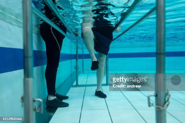 senior man doing physical therapy in the water - hydrotherapy stock pictures, royalty-free photos & images