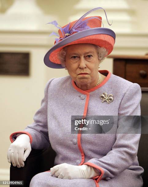 Queen Elizabeth II visits with a group of local school children in Virginia's State Capitol building, inside the old Senate chamber in Richmond,...