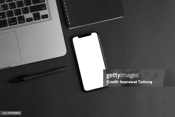 black office desk table with laptop,smartphone and supplies. top view with copy space, flat lay. - table top imagens e fotografias de stock