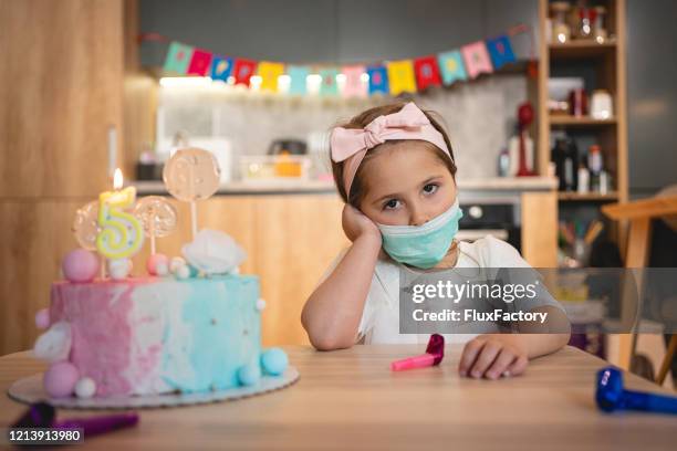 sad and lonely girl celebrating her birthday at home quarantine becuse of coronavirus pandemic - sad birthday stock pictures, royalty-free photos & images