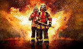Two firefighters go through the fire