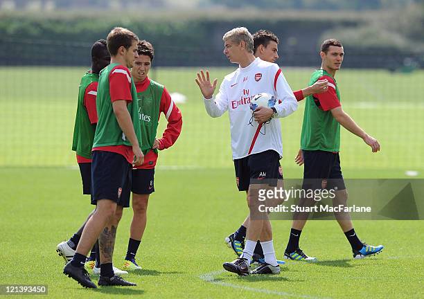 Emmanuel Frimpong; Aaron Ramsey and Samir Nasri talk with Arsenal manager Arsene Wenger during a training session at London Colney on August 19, 2011...