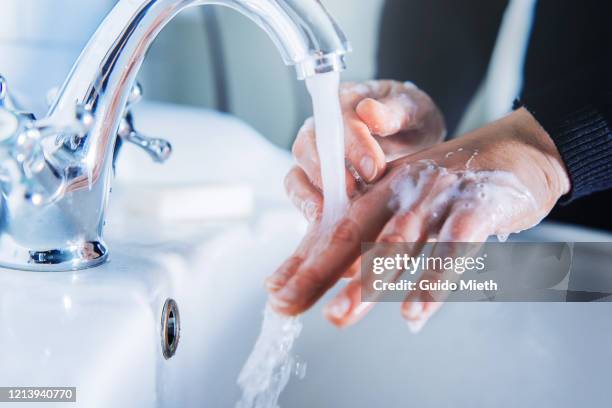 washing hand at home. - washing hands close up stock pictures, royalty-free photos & images