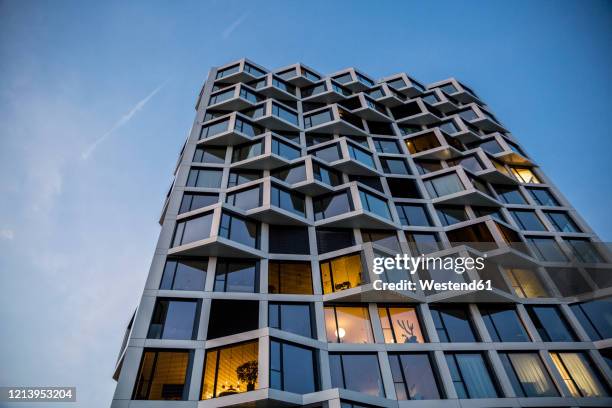 modern high-rise residential building in the evening, munich, germany - german modern architecture stock pictures, royalty-free photos & images