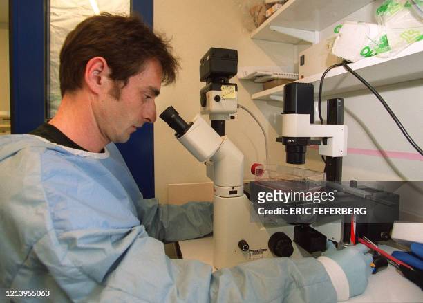 Le généticien Pierre Charneau, chercheur à l'Institut Pasteur, effectue une manipulation, le 04 mai 2000 à Paris, dans l'unité d'oncologie virale...