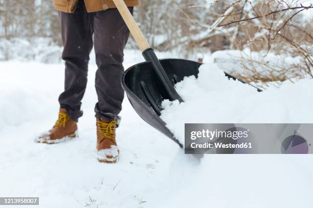 crop view of man shoveling snow - snow shovel 個照片及圖片檔