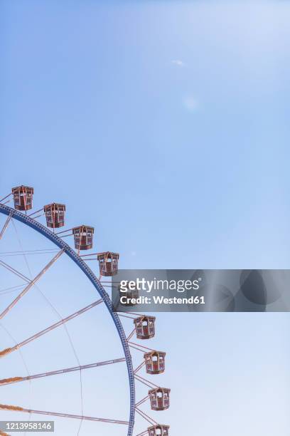 germany, bavaria, munich, low angle view of ferris wheelstanding against clear sky - theresienwiese stock-fotos und bilder
