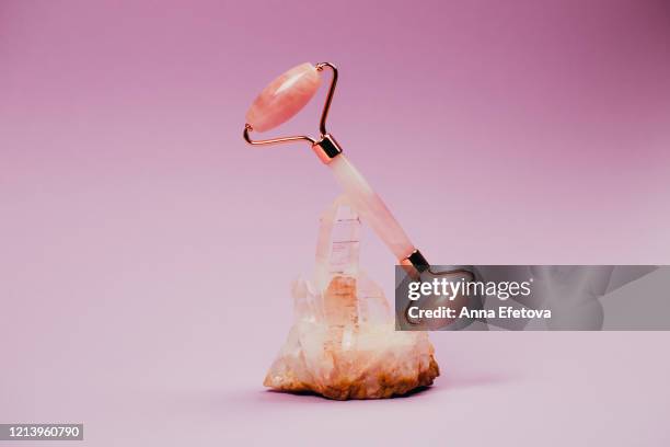 quartz face roller on a stone - clear quartz stock pictures, royalty-free photos & images