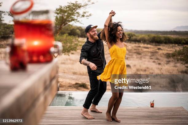 happy couple dancing on deck of a lodge, cape town, south africa - tipo di danza foto e immagini stock
