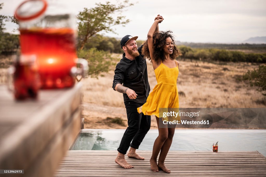 Happy couple dancing on deck of a lodge, Cape Town, South Africa