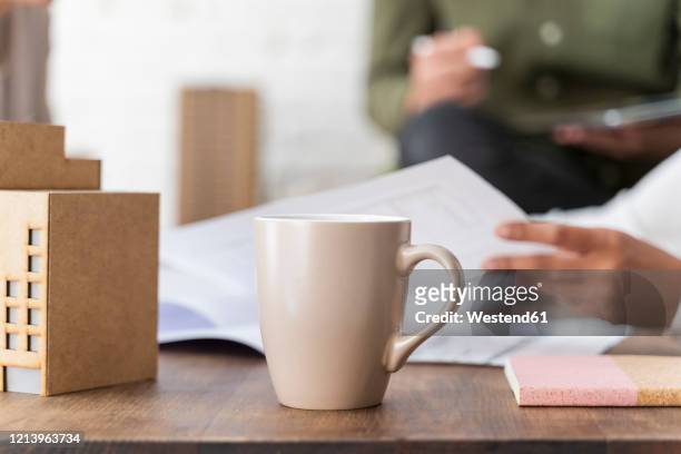 close-up of desk in architectural office - cup office stock pictures, royalty-free photos & images