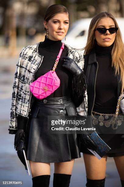 Paulina Swarovski and Victoria Swarovski, wearing a black turtleneck top, black mini skirt, black and white jacket, Chanel fuchsia bag, black gloves...