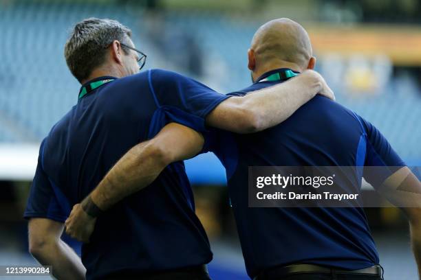 North Melbourne Senior Assistant coach Jade Rawlings and Senior Coach Rhyce Shaw embrace after their team win during the round 1 AFL match between...