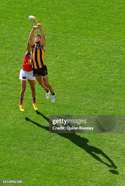 Charlie Cameron of the Lions and Ben Stratton of the Hawks compete for a mark during the round 1 AFL match between the Hawthorn Hawks and the...