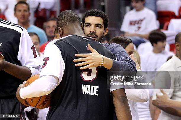 Recording artist Drake greets LeBron James of the Miami Heat prior to the start of Game Three of the Eastern Conference Finals against the Chicago...