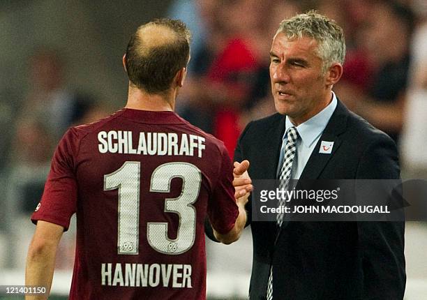 Hanover's head coach Mirko Slomka congratulates Hanover's striker Jan Schlaudraff after he was subsituted during the UEFA Europa League play off...