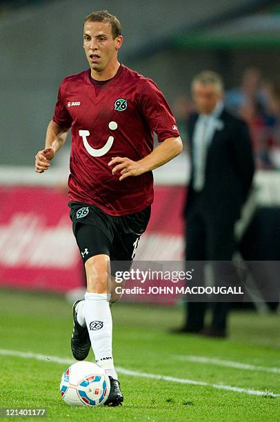 Hanover's striker Jan Schlaudraff runs with the ball during the UEFA Europa League play off match Hanover 96 vs FC Sevilla in the northern German...