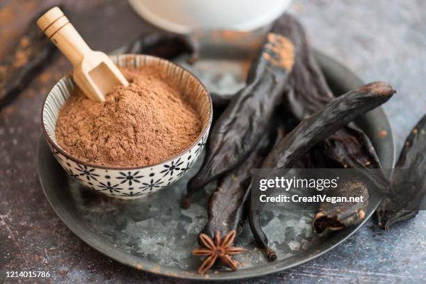 carob powder and pods - brown powder stock pictures, royalty-free photos & images