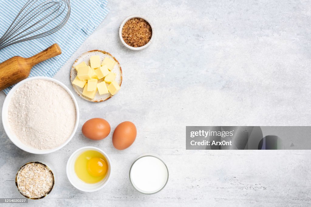 Baking ingredients on grey concrete background