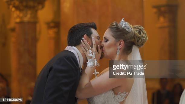 bride and groom kissing after wedding ceremony on church - victory parish stock pictures, royalty-free photos & images