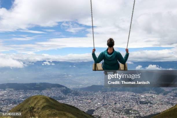 view of quito from a swing on pichincha volcano - vertige photos et images de collection