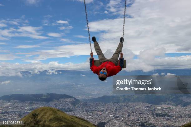 view of quito from a swing on pichincha volcano - quito stock pictures, royalty-free photos & images
