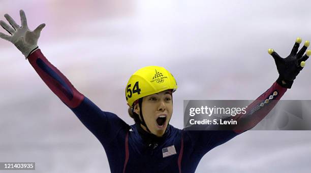 Apolo Anton Ohno of the United States celebrates winning a gold medal during the Short Track Speed Skating 500 m at the 2006 Olympic Games held at...