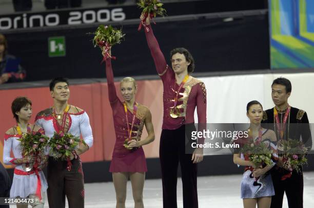 Gold medalist Maxim Marinin and his partner Tatiana Totmianina receive their gold medal along with silver medalists Dan Zhang and Hao Zhang, left and...