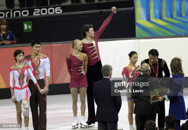 Gold medalist Maxim Marinin and his partner Tatiana Totmianina wave to the crowd along with silver medalists Dan Zhang and Hao Zhang, left and bronze...