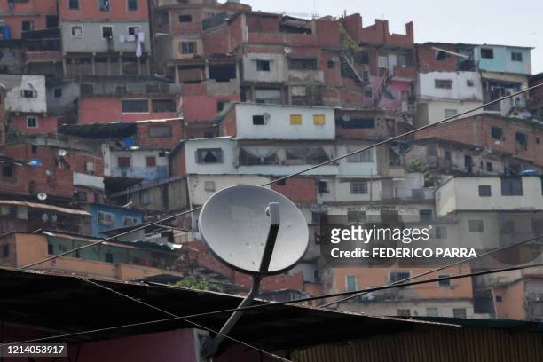 View of a DirecTV dish antennas installed on a house at the Petare neighborhood in Caracas on May 19, 2020. US telecommunications giant AT&T...