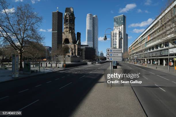 The Kaiser Wilhelm Memorial Church stands next to empty Budapester Strasse at Breitscheidplatz square on March 22 in Berlin, Germany. Everyday life...