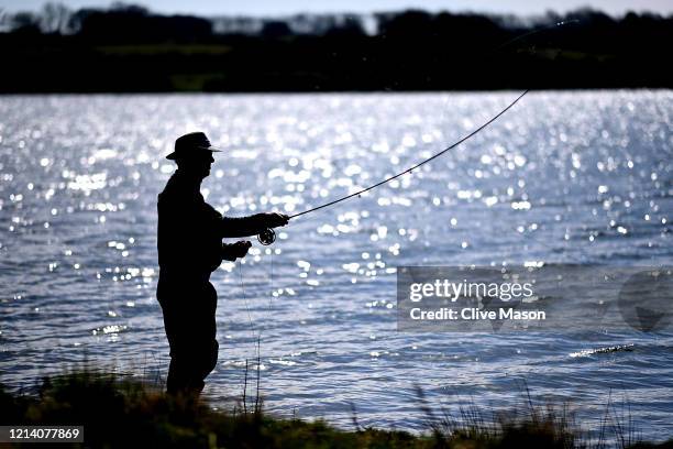 Fishermen continue to fish as the public comes to terms with social distancing and the lack of Sport at Pitsford Reservoir on March 22, 2020 in...