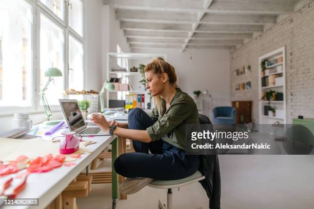 finishing work online from home office - freelance work stock pictures, royalty-free photos & images