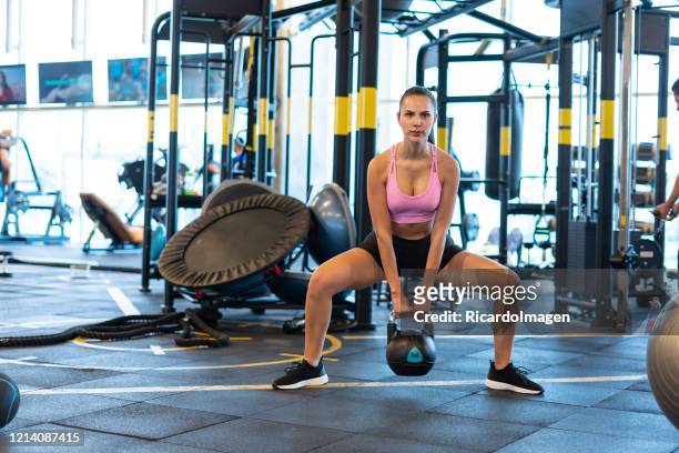 latin woman using dumbbell in the gym - hispanoamérica stock pictures, royalty-free photos & images