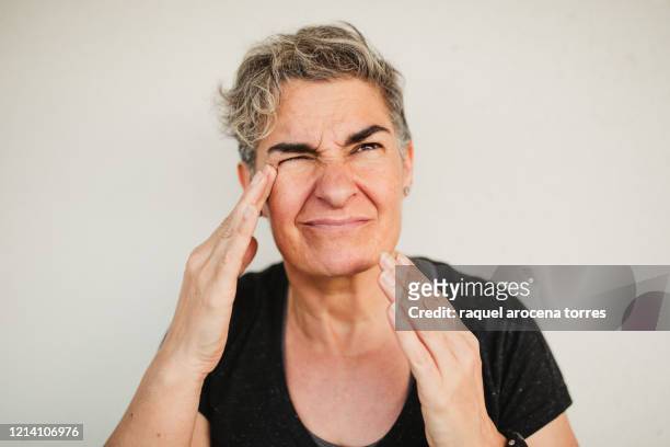 adult woman suffering headache - pain face portrait bildbanksfoton och bilder