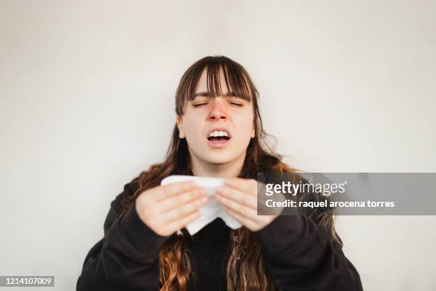close uo view of young woman suffering spring allergy - blowing nose stock pictures, royalty-free photos & images