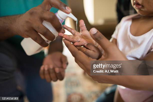 keeping hands clean - hand sanitiser stock pictures, royalty-free photos & images