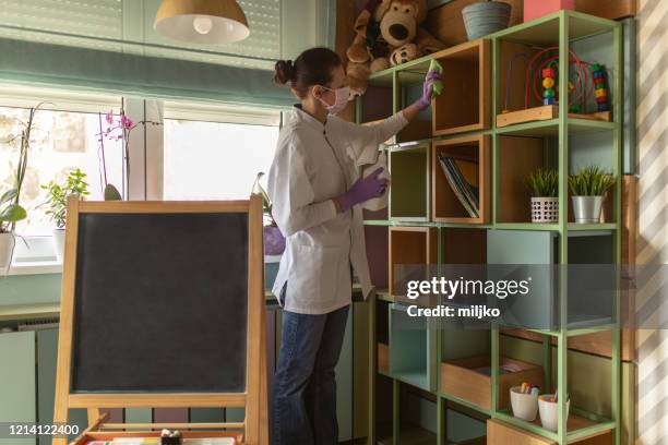 female doctor cleaning kindergarten - disinfection school stock pictures, royalty-free photos & images