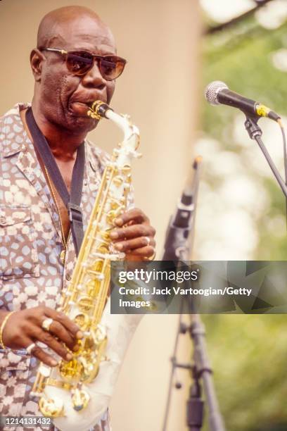 Cameroonian Makossa musician and bandleader Manu Dibango plays alto saxophone with his band as he performs onstage at Central Park SummerStage, New...
