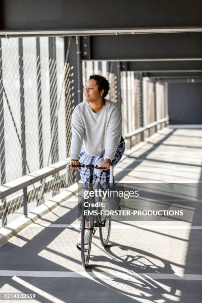 portrait of sporty, young and curvy woman with road bike in the city - bicycle parking station stock pictures, royalty-free photos & images